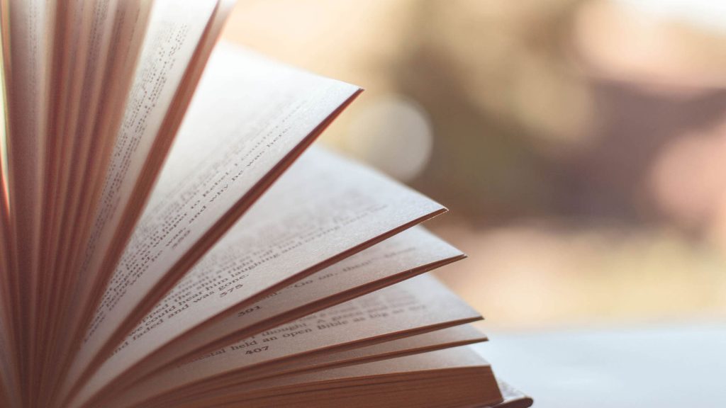 a book is placed open on a table and the pages are flicking through