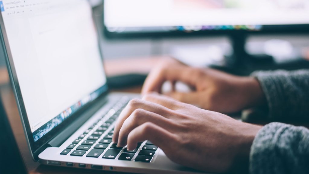 Person typing on a laptop