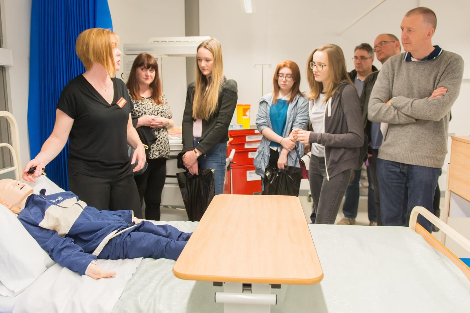 Prospective students and their family members take a tour of the clinical skills facilities during an open day.
