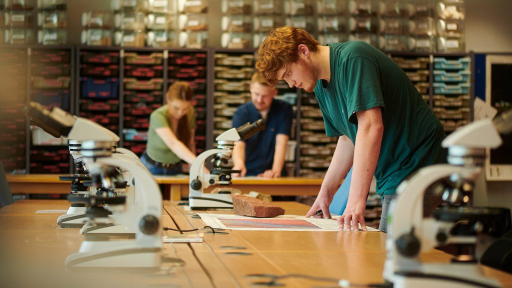 Geography students using microscopes in the lab