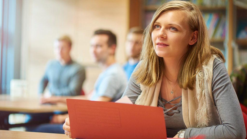 Student looking up from a laptop