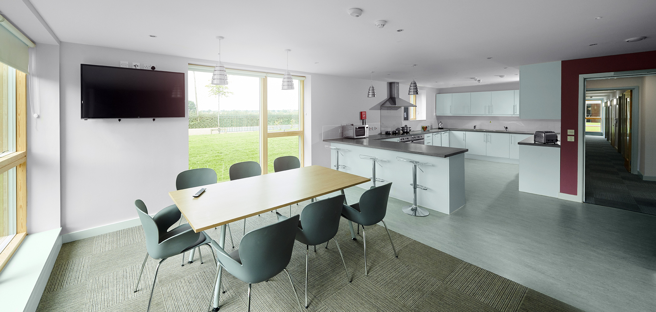 Dining area in the foreground, with kitchen to the rear in Palatine Court.