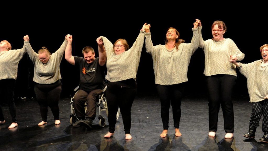 A group of research participants on a stage
