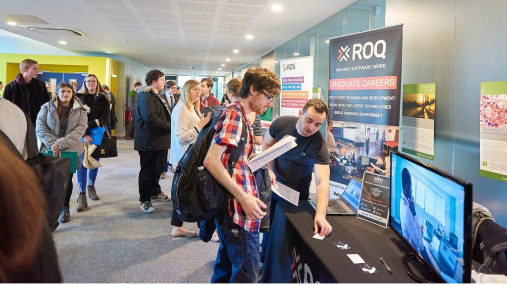 People interacting at stands in the computing fair at Edge Hill.
