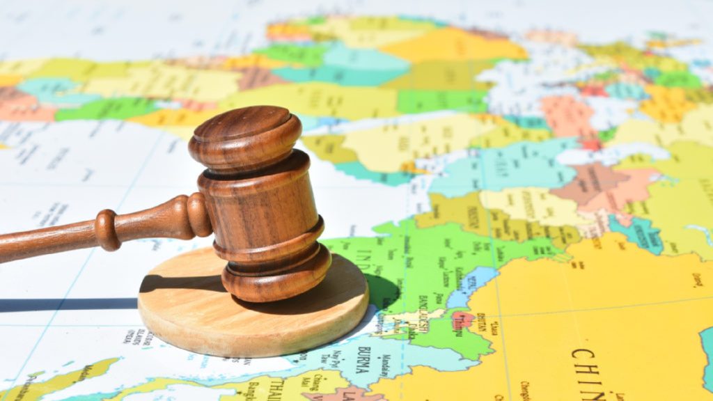 An image of a gavel hitting a map.