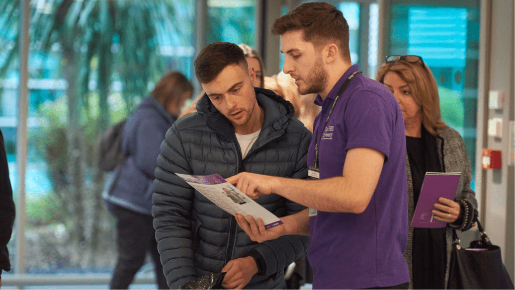 An image of a student advisor helping a prosepctive student on an open day.