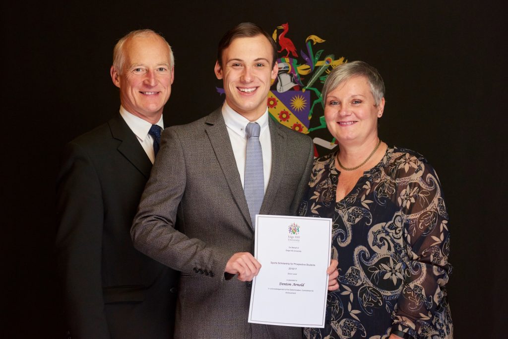 Sports Scholarship winner Emma Nicholson, with her family, showing her certificate at a Scholarship Awards Evening.