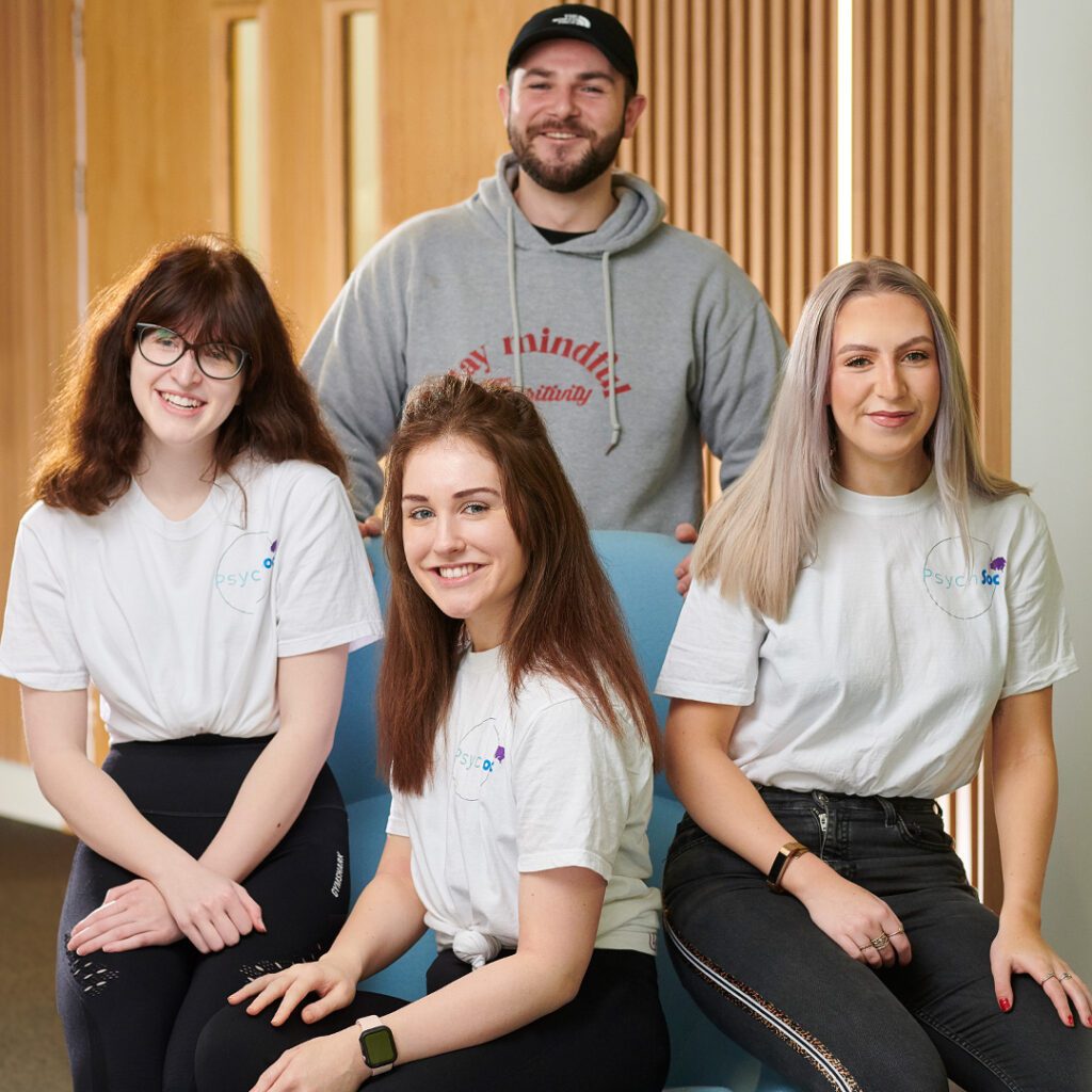 Four members of the Psychology Society smiling.