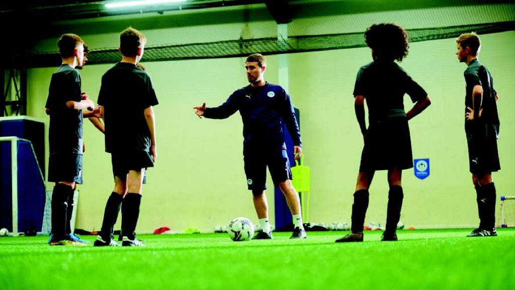 student teaching a football class