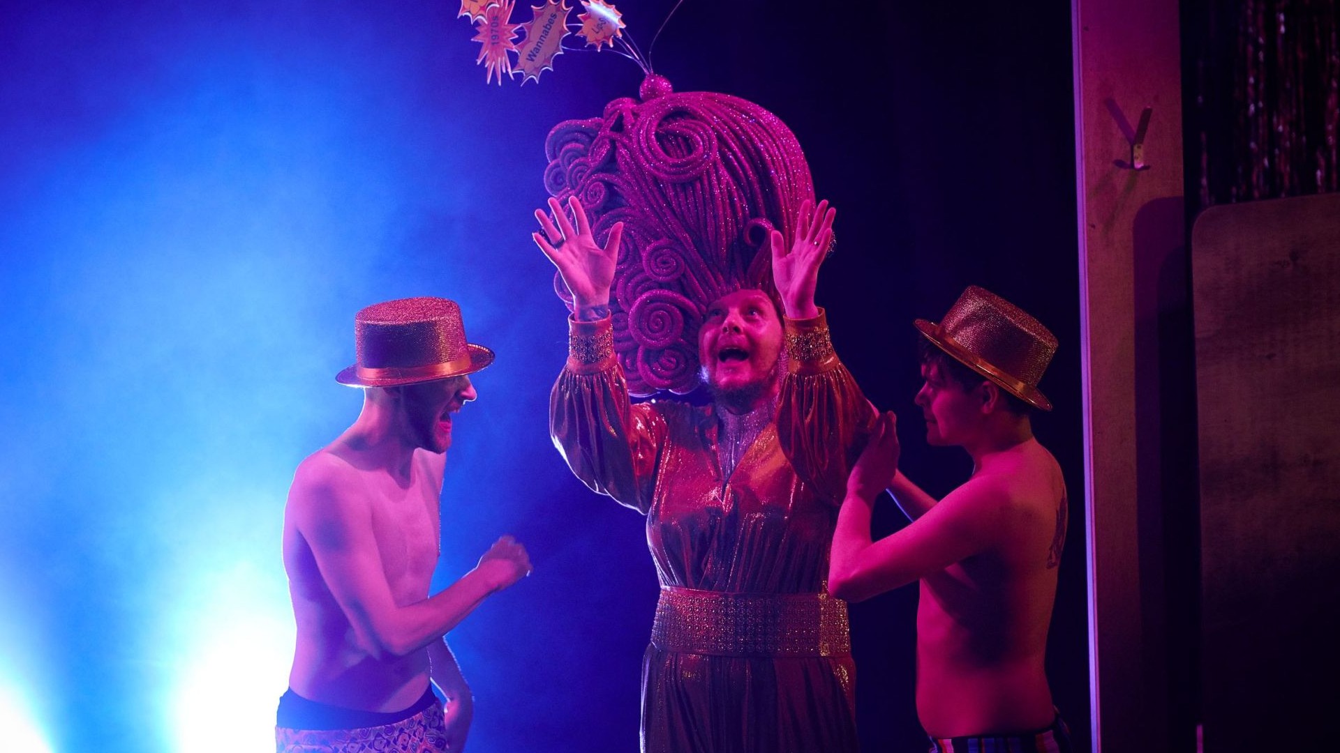 An image of three people performing on a stage.
