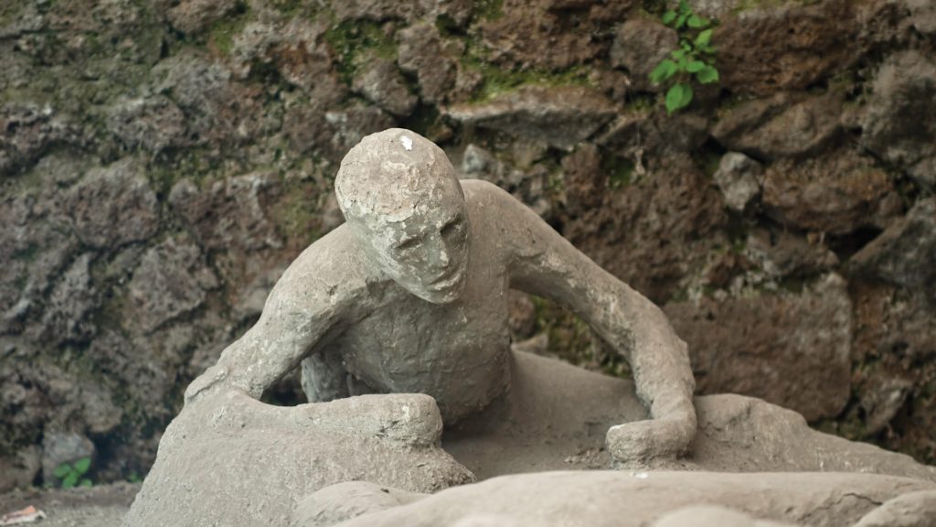 An image of a stone statue on the ground.