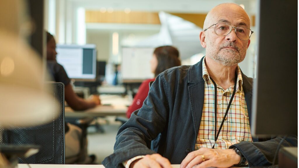 Mature students sat at a computer