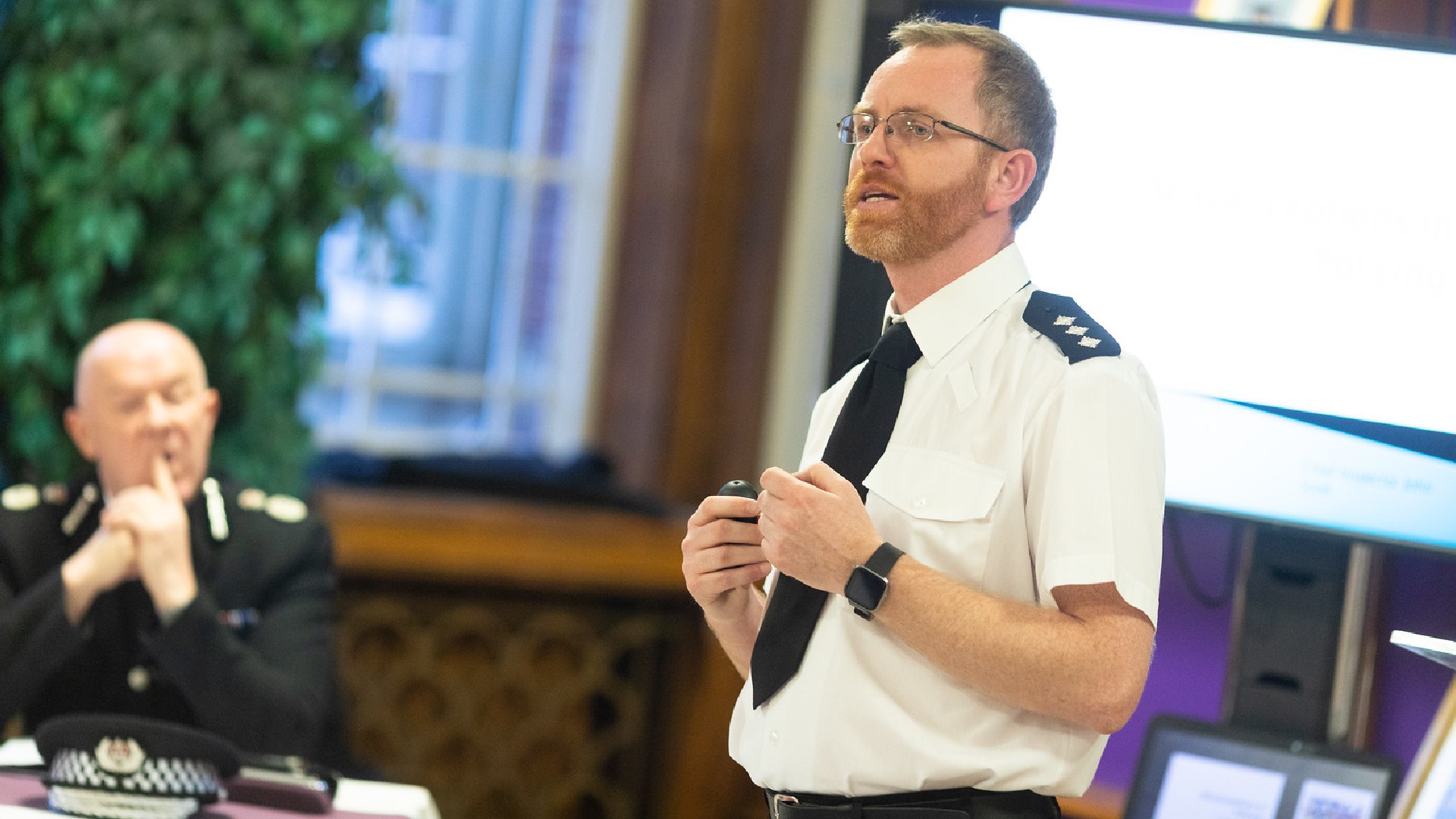 Police offer giving a speech at an on campus awards ceremony