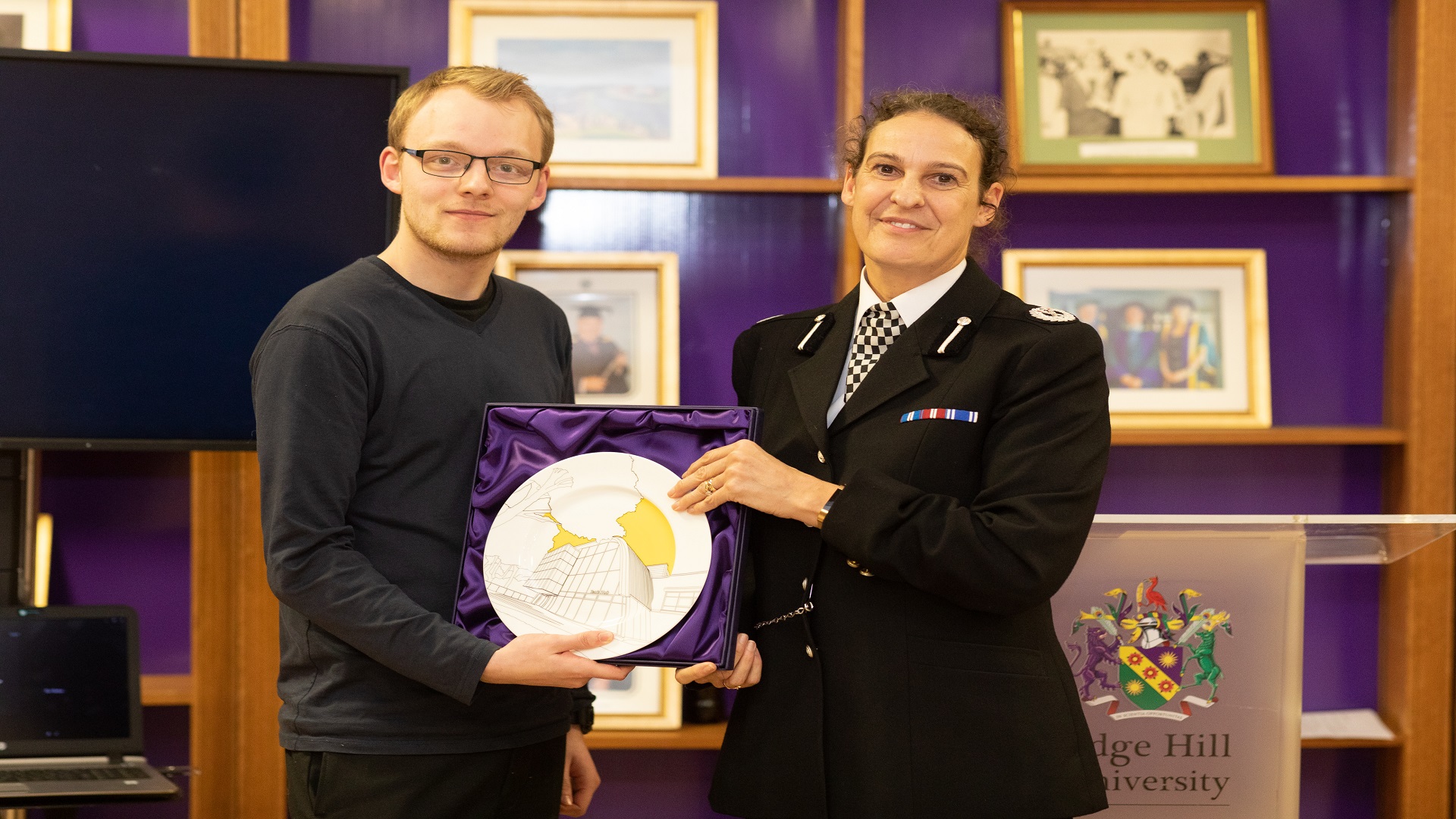 police professional handing award to student