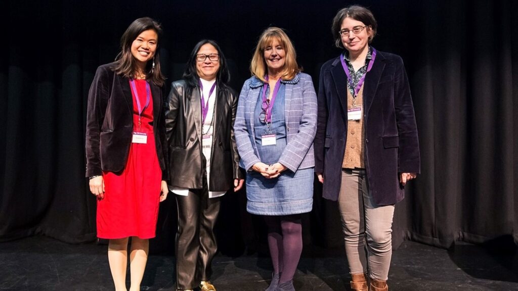 The organisers and speakers at the Healthy Brain showcase stand in a line on the stage.