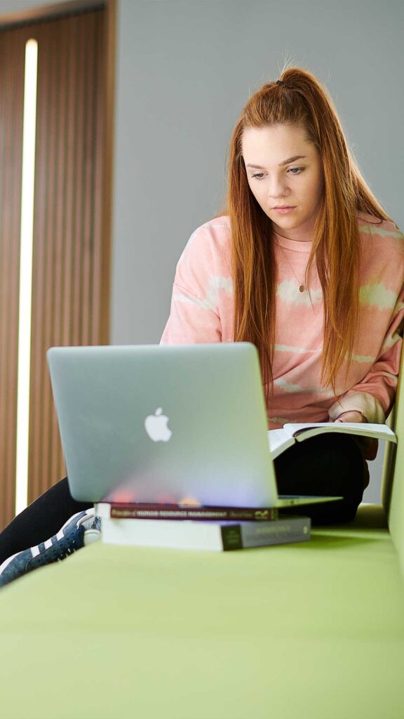 female student working on a laptop