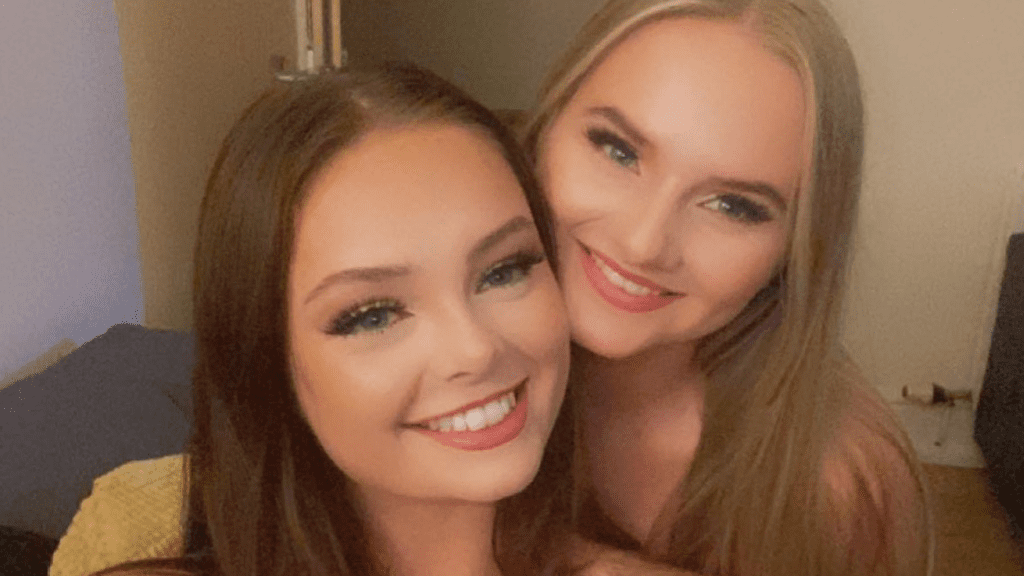 Freya and Eva take a selfie. They are smiling to camera.
