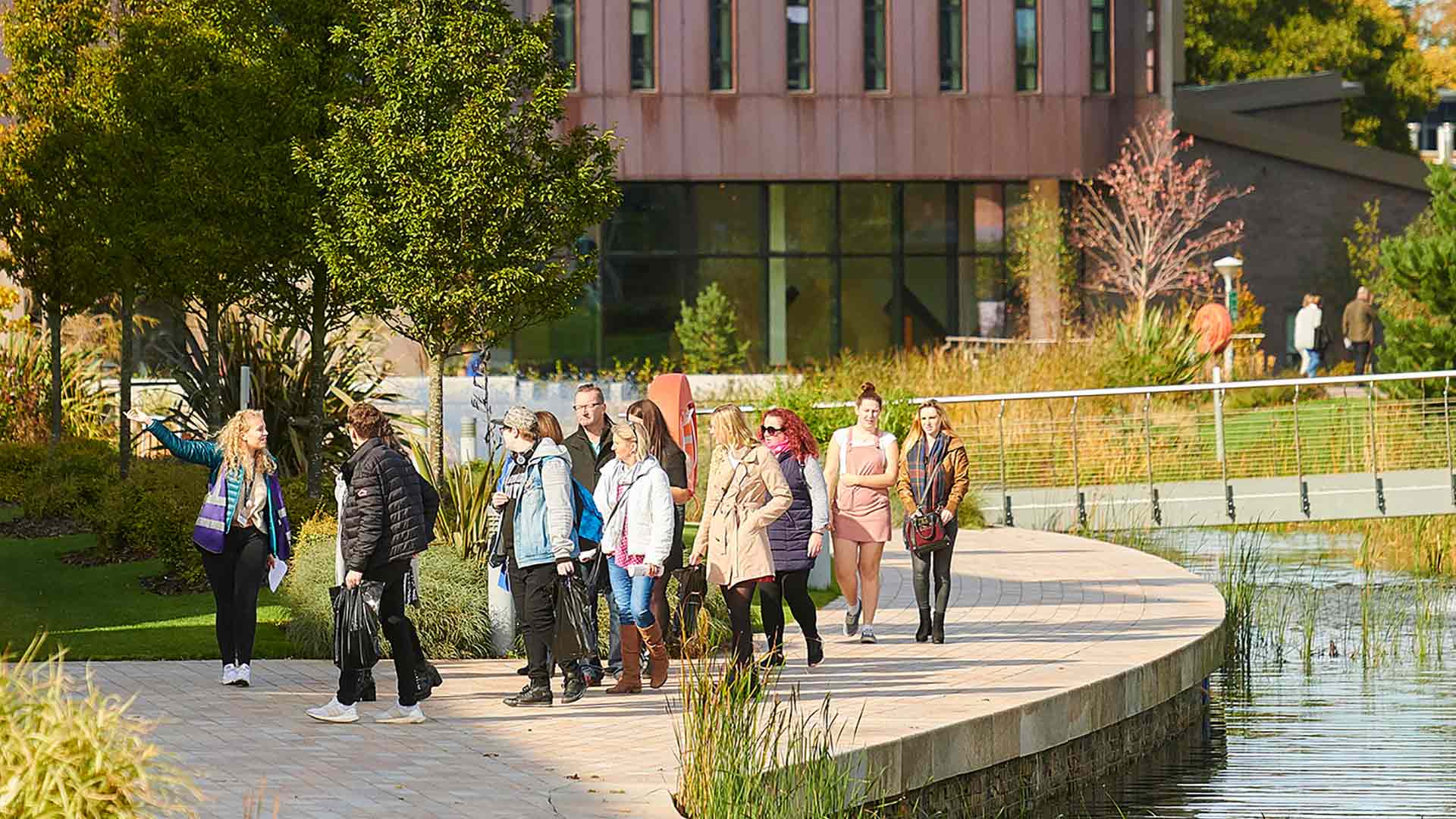 A student guide leads a group of prospective students and their family members on a tour of the campus, seen here near the Catalyst building.