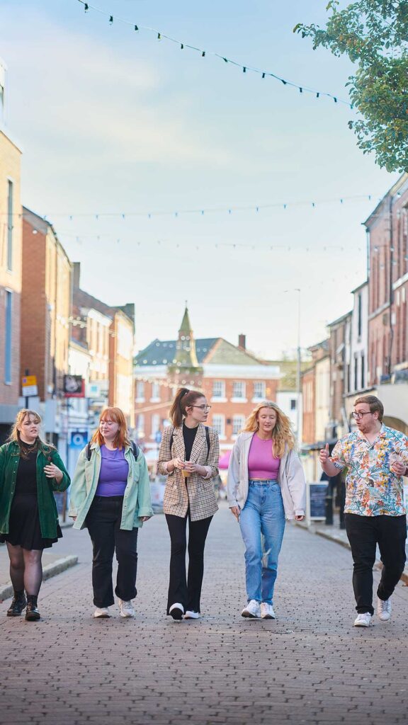 group of male and female students walking together through Ormskirk