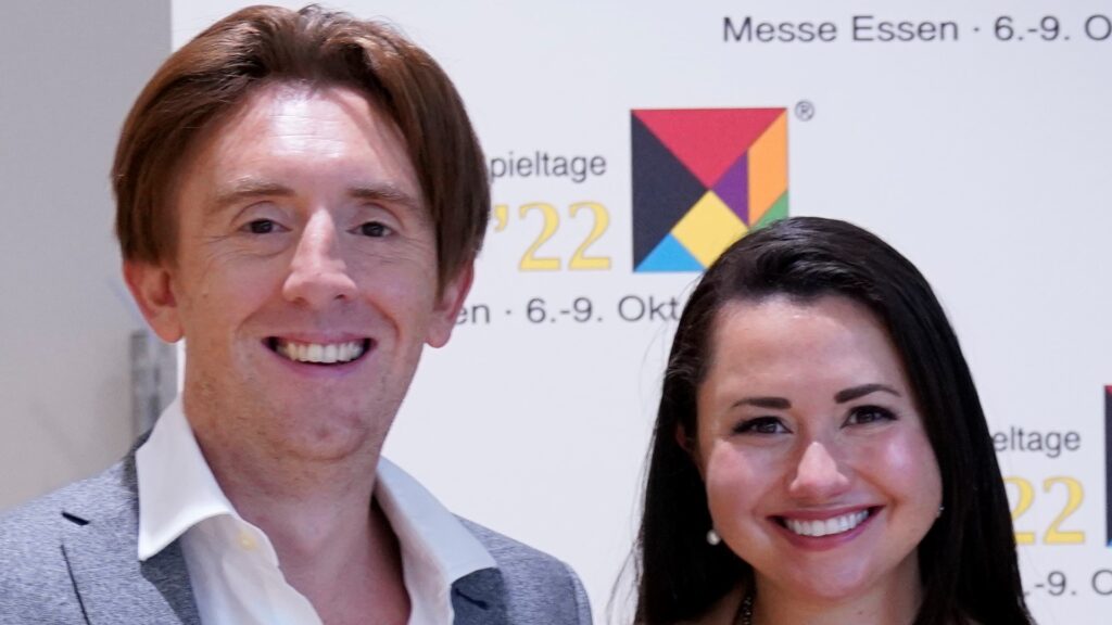 Dr Liam Cross and Dr Gray Atherton stand close together and smile at the camera.