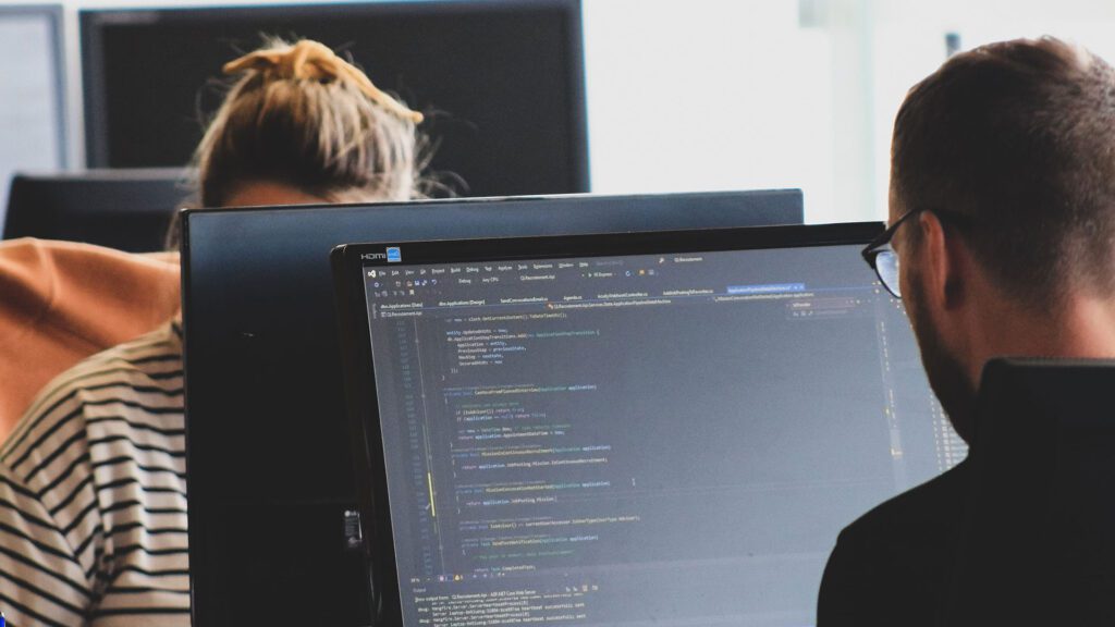 Student working on coding at a computer.