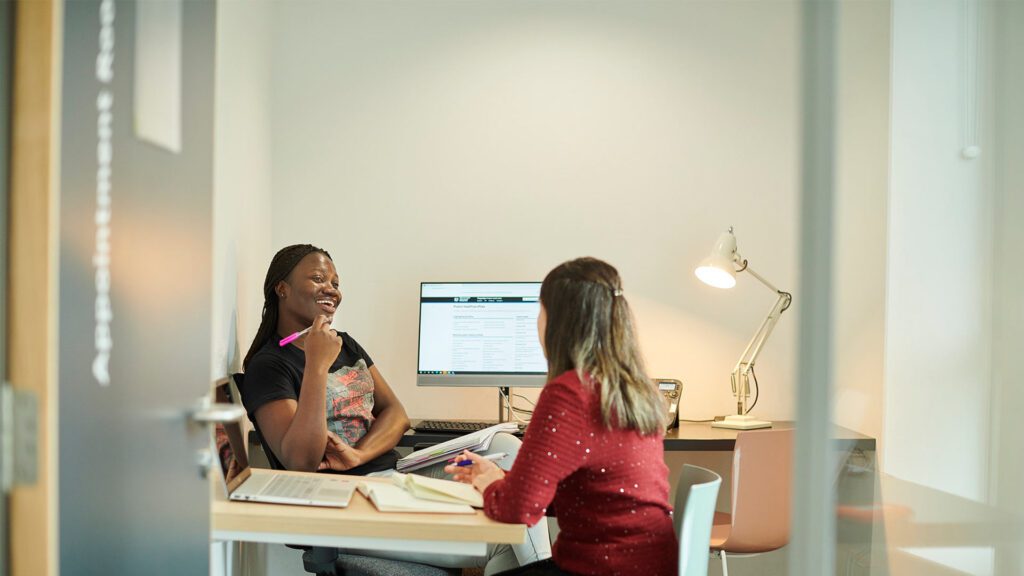 Student talking to a tutor.