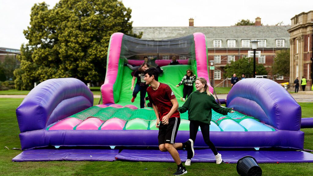 Students on an inflatable assault course during Induction Week