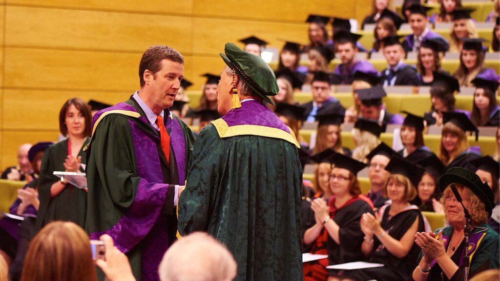 Peter Hooten accepting an honorary doctorate