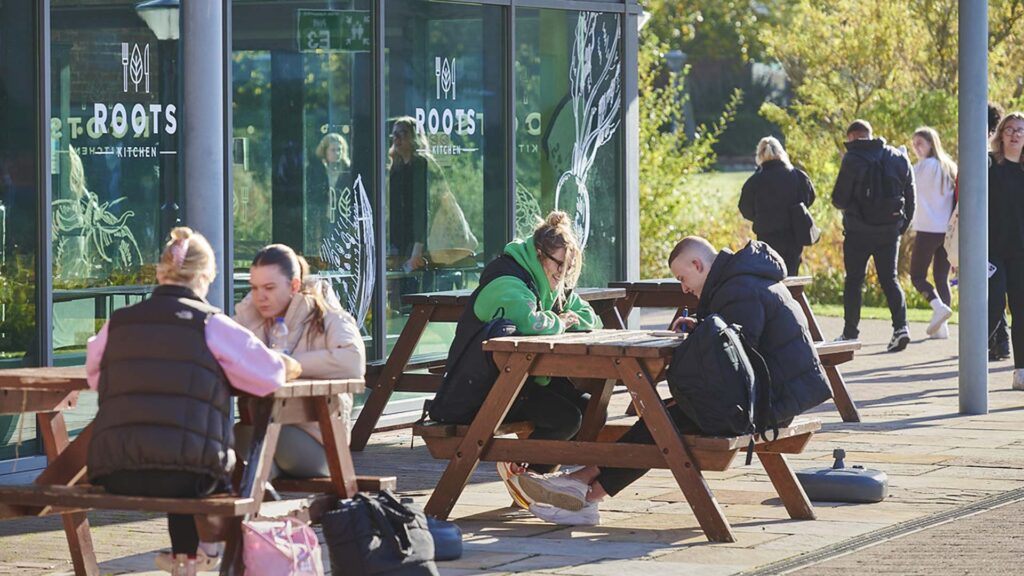 Students sit outside Roots kitchen