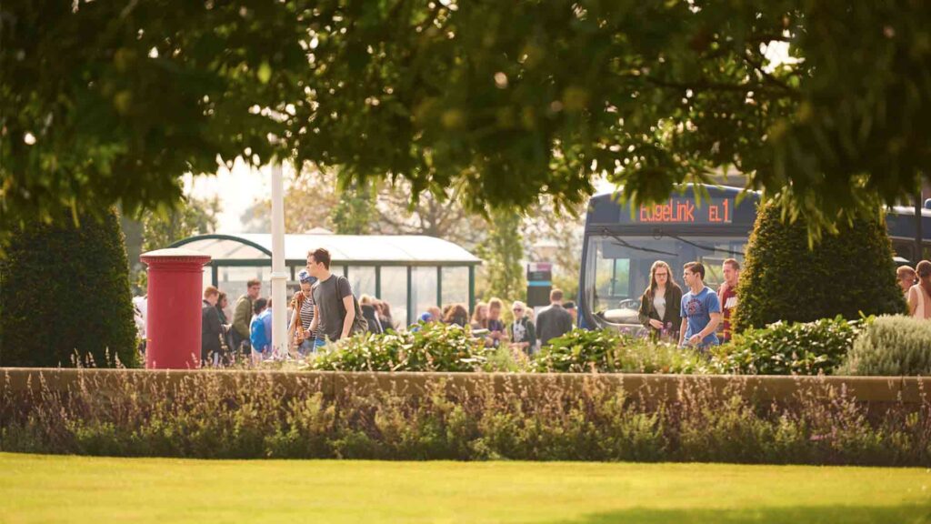 Image of students getting off Edge Link Bus at the bus stop on campus