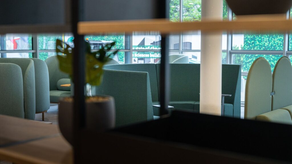 interior shot of the hub after redevelopment. Image shows close up of bookshelves and seating area