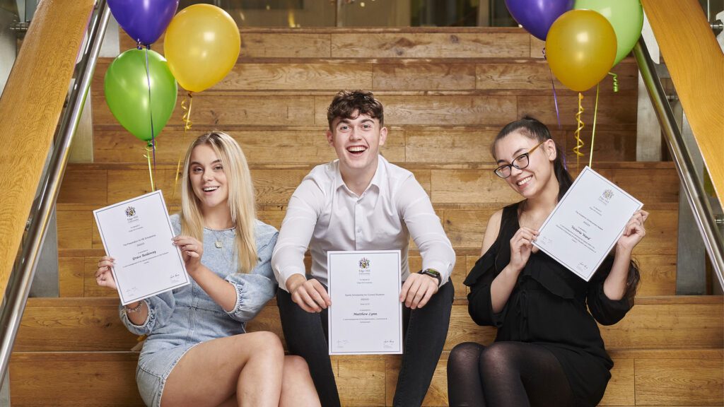 Three students pose with their certificates at the Scholarships Awards 2022.