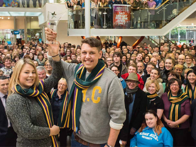 Staff and students pose in the Hub to celebrate University of the Year award