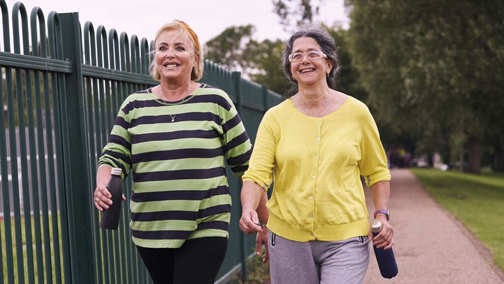 Two people taking a walk and smiling