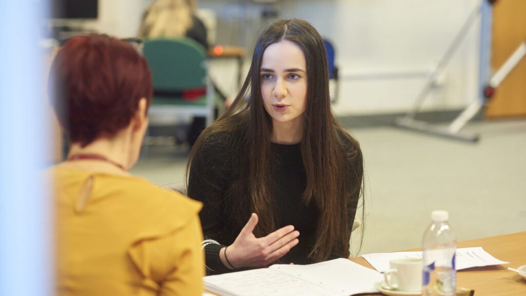 A counselling and psychotherapy student talks to a tutor