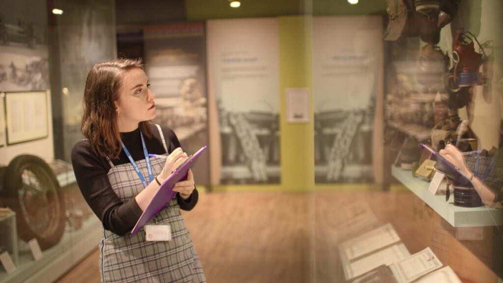 A student looking at a museum exhibit during an Edge Hill field trip