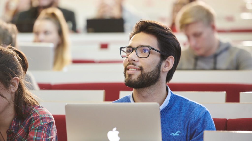 Students of Teaching English to Speakers of Other Languages make notes during a lecture