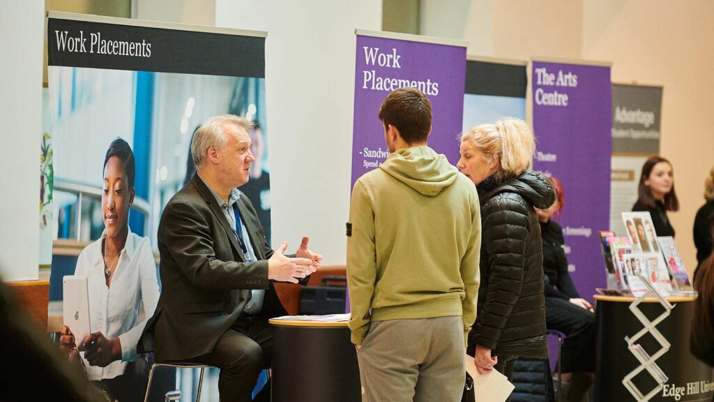 Member of staff discussing work placements with prospective student.