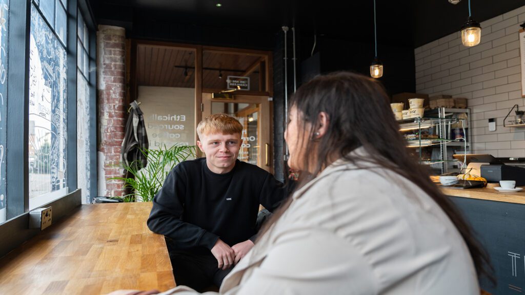 Two students enjoying coffee and chatting at Two Brothers coffee in Ormskirk