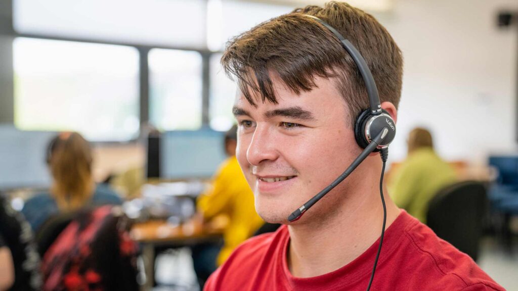 Someone on our Clearing helpdesk taking a call on Clearing day.