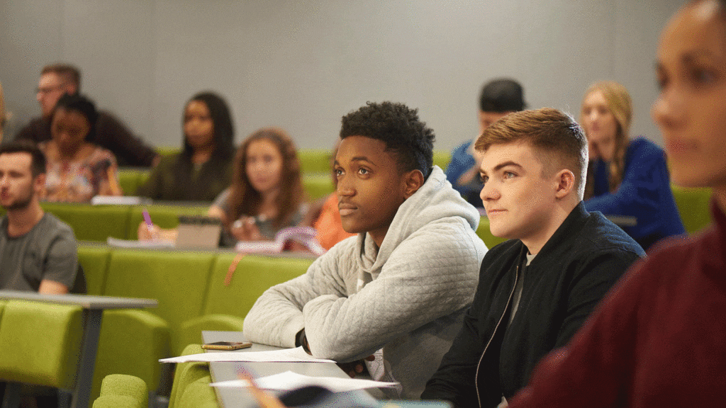 Students sat in a lecture theatre.