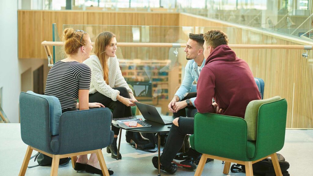 121 session between students and staff in Catalyst building on campus