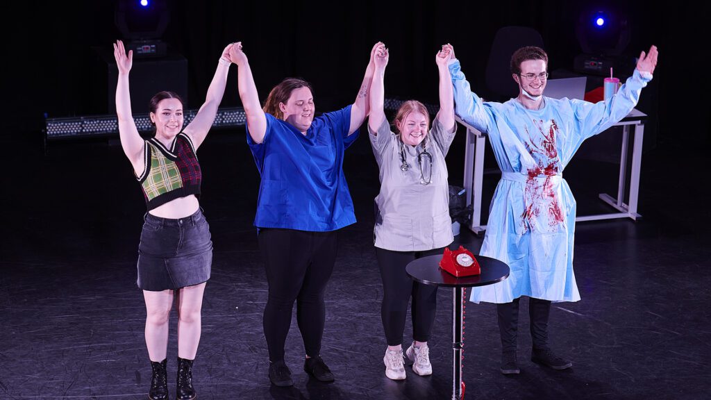 Edge Hill students take a bow on stage after a performance.
