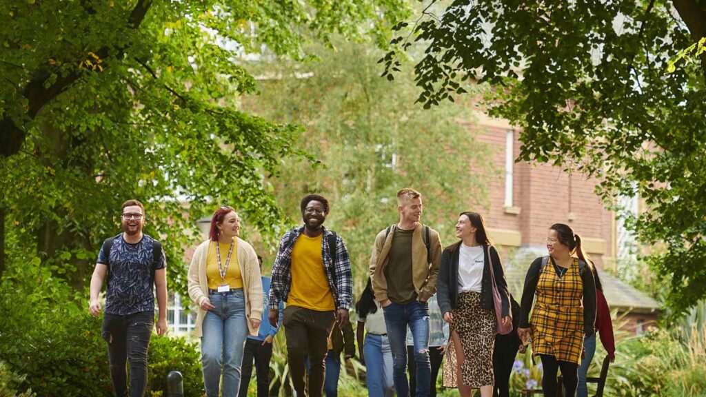 A group of students walk across campus