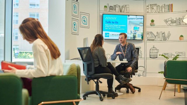 Careers advisor discussing topics with student at the Careers Corner helpdesk area