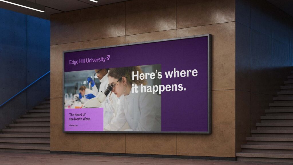 A mock up of a large, landscape poster on a wall, with the message, "Here's where it happens".