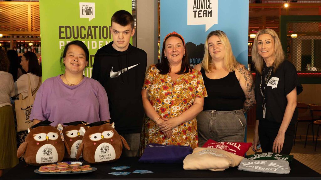 a stand in the EHSU building showing a group of student union support staff