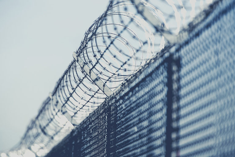 Restricted Area Barbed Fence Closeup Photo in Bluish Color Grading