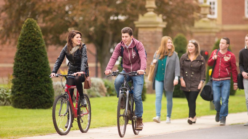 group of students cycling on campus