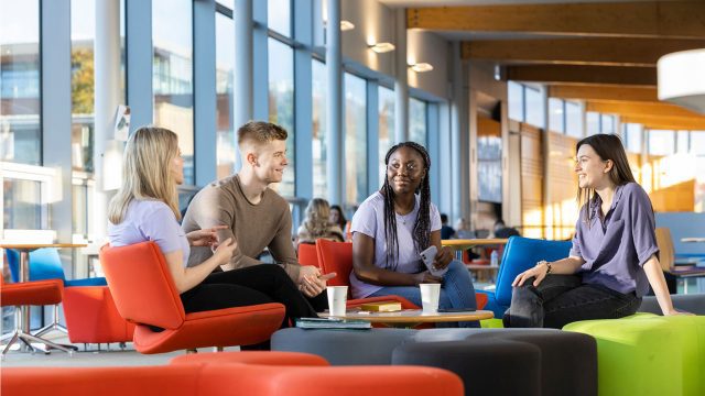 Students chatting upstairs in the Hub.